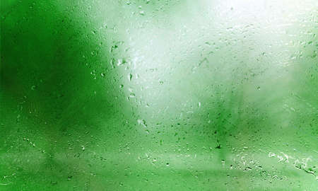 Water drops on glass with a green background. Water drops on the glass.の写真素材