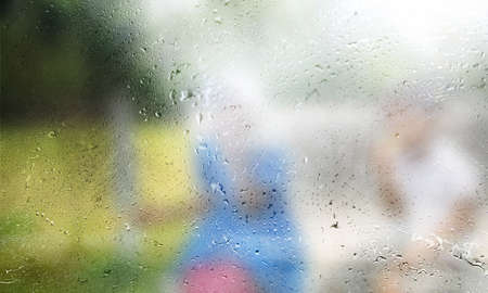 Rain drops on the glass, blurred background. Rainy weather.