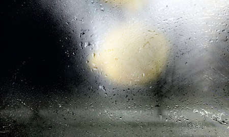 Drops of rain on the glass close-up. Raindrops on the window, abstract background