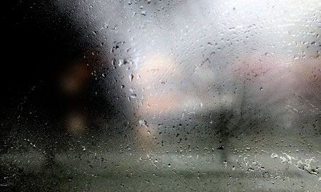 Water drops on glass with blurred background. Raindrops on the window.