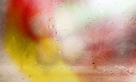 Water drops on the glass with a blurred background. Abstract background.