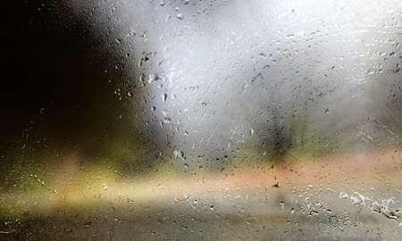 Rain drops on the window. Raindrops on the glass. Blurred background.