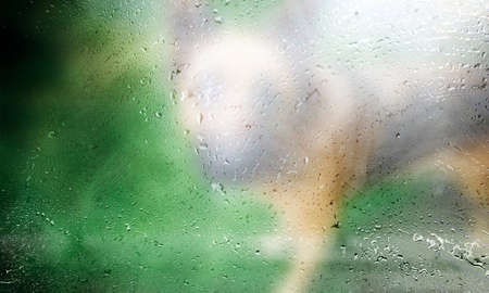 Drops of rain on the window, blurred background. Rainy weather