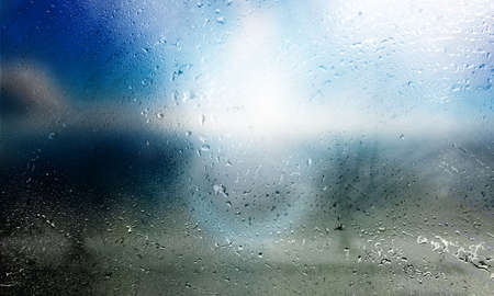 Rain drops on window glass with blurred background and copy space for your text