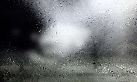Rain drops on the window glass with a blurred background. High quality photo