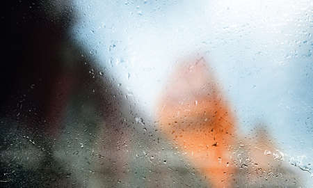 Rain drops on the window, blurred background. Water drops on glass.