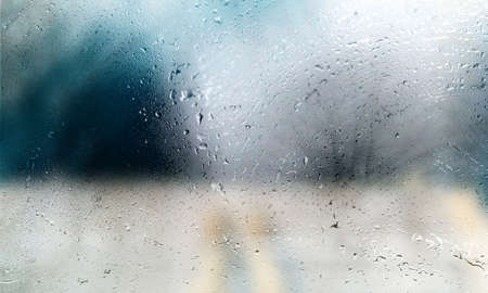 Rain drops on the window, close-up, blurred background.