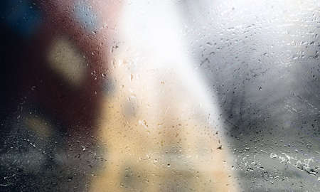 Drops of rain on the window, blurred background. Rainy weather.