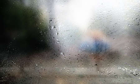 Drops of rain on the window, blurred background. Rainy weather.