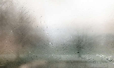 Drops of rain on the window. Rainy weather background.