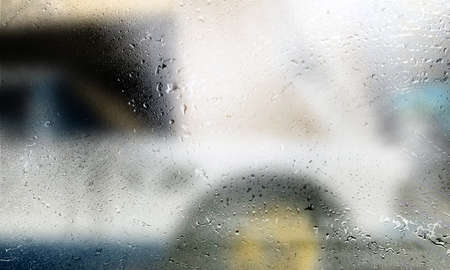 Drops of rain on the window, close-up view, blurred background