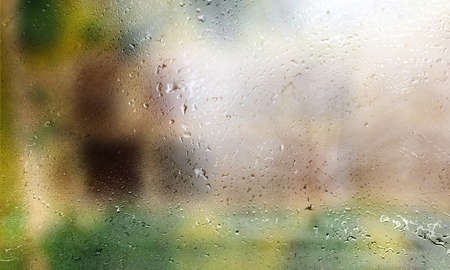 Drops of rain on the window, blurred background with bokeh