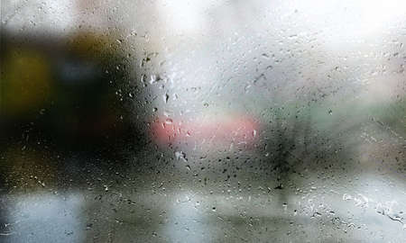 Drops of rain on the window, blurred background. Rain drops on the glass, rainy weather.