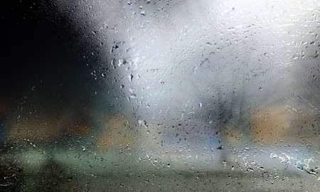 Drops of rain on the window, blurred background. Rainy weather