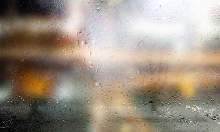 Drops of rain on the window, blurred background. Rainy weather.