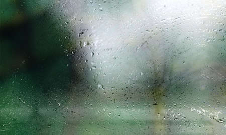 Drops of rain on the window, blurred background. Raindrops on the glass, natural background.