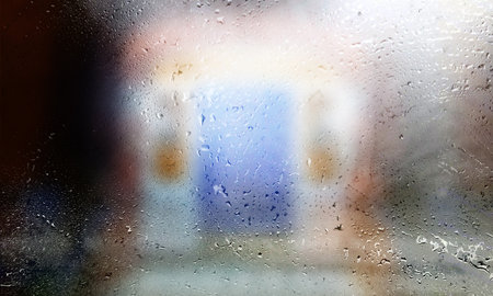 Drops of rain on the window, blurred background. Condensation on the glass.