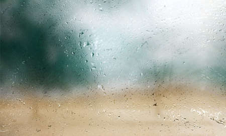 Water drops on glass with blurred background. Raindrops on window.の写真素材