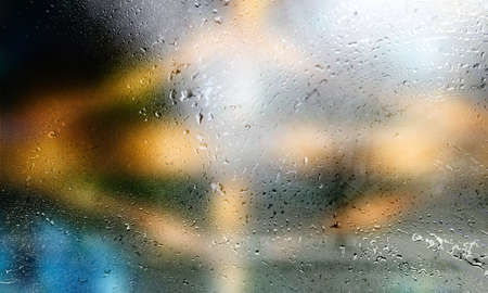 Drops of rain on the window, close-up. Rain drops on glass surface, background with copy space for...