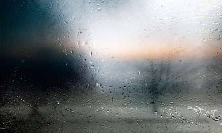 Condensation on the window. Rain drops on the glass. Blurred background.