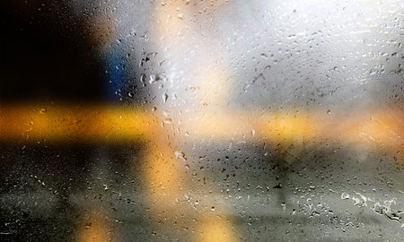 Drops of rain on the window, blurred background. Rainy weather.の写真素材