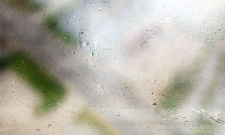 Water drops on glass with blurred background. Rain drops on window.