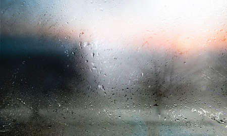 Rain drops on the window, close-up view, blurred background