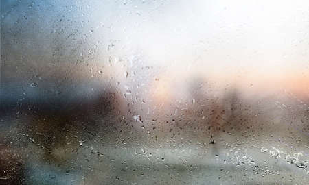 Drops of rain on the window, blurred background, rainy weather.