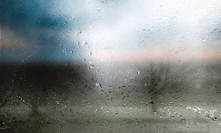 Rain drops on window glass. Raindrops on window glass close-up. Rainy weather.