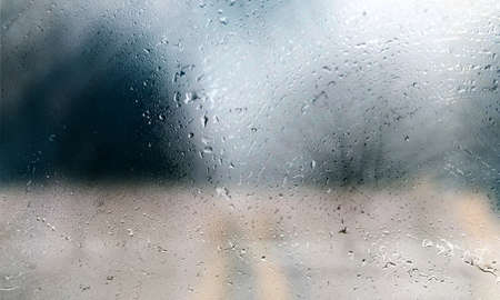 Drops of rain on the window, close-up, blurred background
