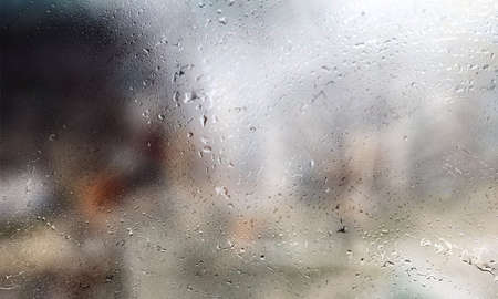 Condensation on the window. Rain drops on the glass, blurred background.