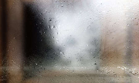 Drops of rain on a window glass, close-up.