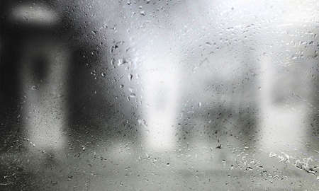 Drops of rain on the glass, blurred background. Rainy weather.の写真素材