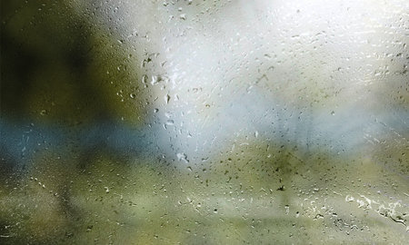 Rain drops on window glass with blurred background. Raindrops on window glass.