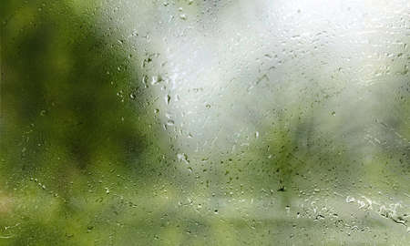 Rain drops on the glass, blurred background, close-up.