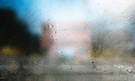 Water drops on the glass with blurred background. Raindrops on the window.
