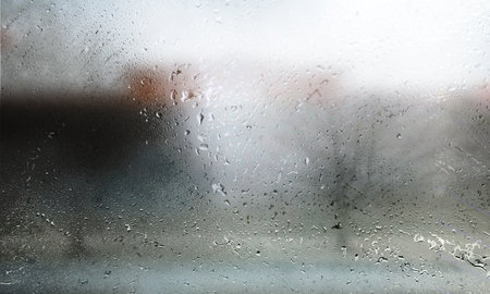 Rain drops on the window, blurred background. Rainy weather.