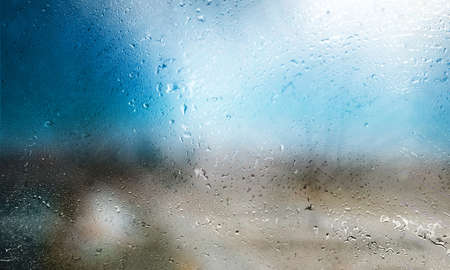 Water drops on the window with blurred background. Rainy weather.