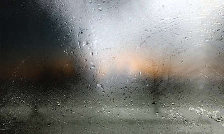 Water drops on glass, blurred background. Raindrops on window glass.