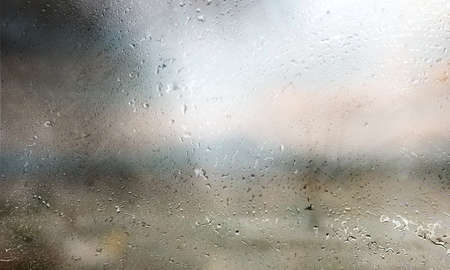 Drops of rain on the window, close-up, blurred background