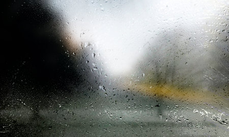 Raindrops on the window, blurred background. Rainy weather.