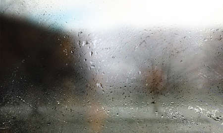 Water drops on the glass. Raindrops on the window, blurred background