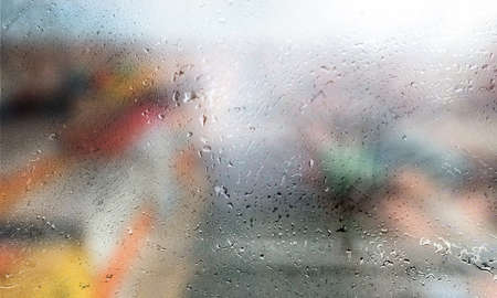 Rain drops on the window, blurred background with bokeh.