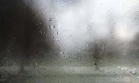 Rain drops on the window, close-up, blurred background.