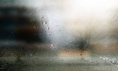 Water drops on window glass. Rainy weather background. Close up