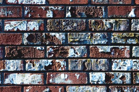 An old weathered brick wall with peeling paintの写真素材