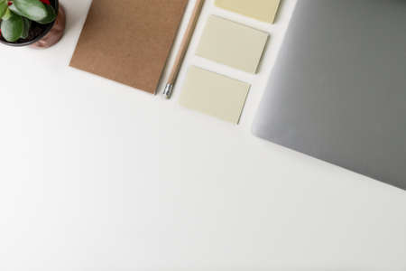 Top view of office workplace. White desk with copy space. Flat lay view on table with laptop,...