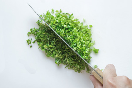 Chopping culantro with knifeの写真素材