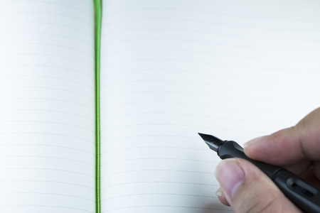 Jotting down on blank noteの写真素材