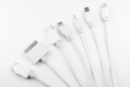 7 different cellphone charging plugs adapter from USB isolated on white backgroundの写真素材